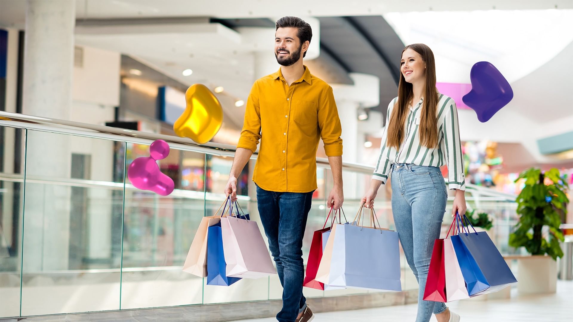 Happy couple walking through a bright mall carrying multiple shopping bags near Camino Real Fashion Drive, Monterrey