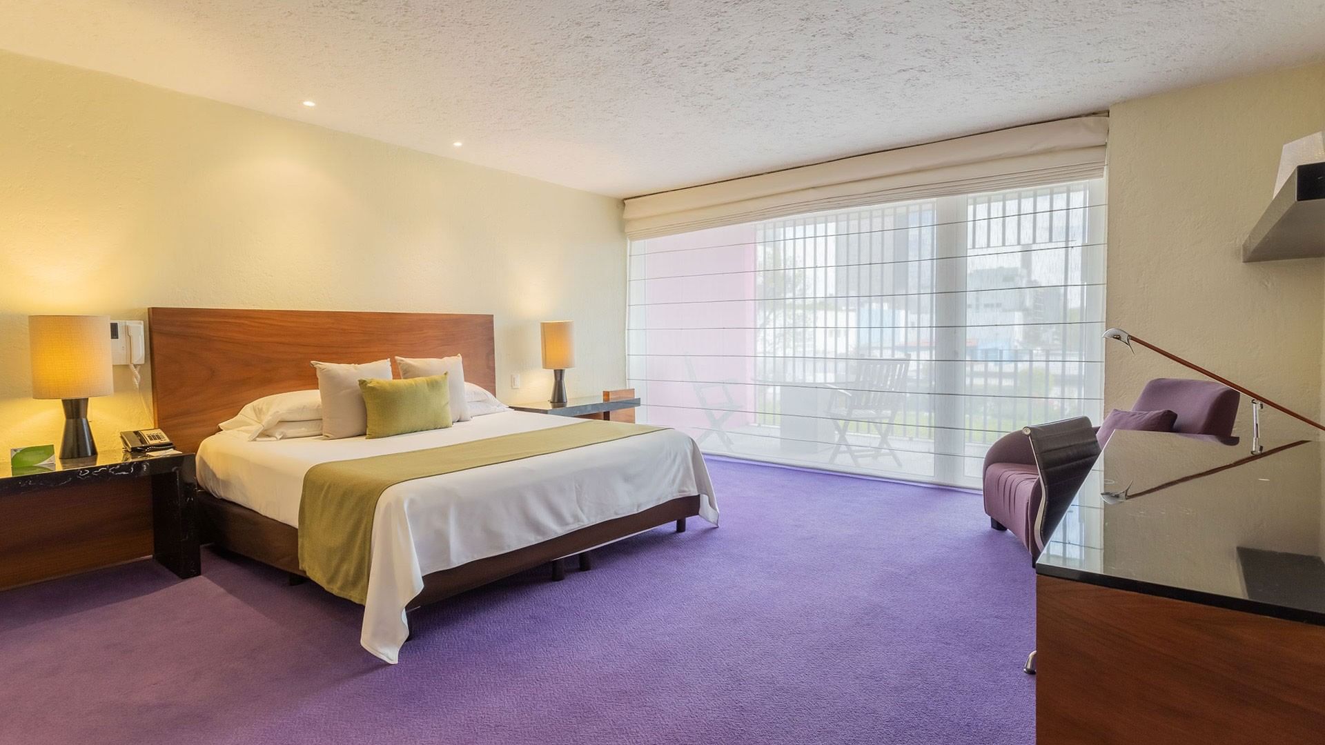 King Viceroys Suite featuring a king bed, purple carpet, and a large sunlit balcony window at Camino Real Polanco Mexico