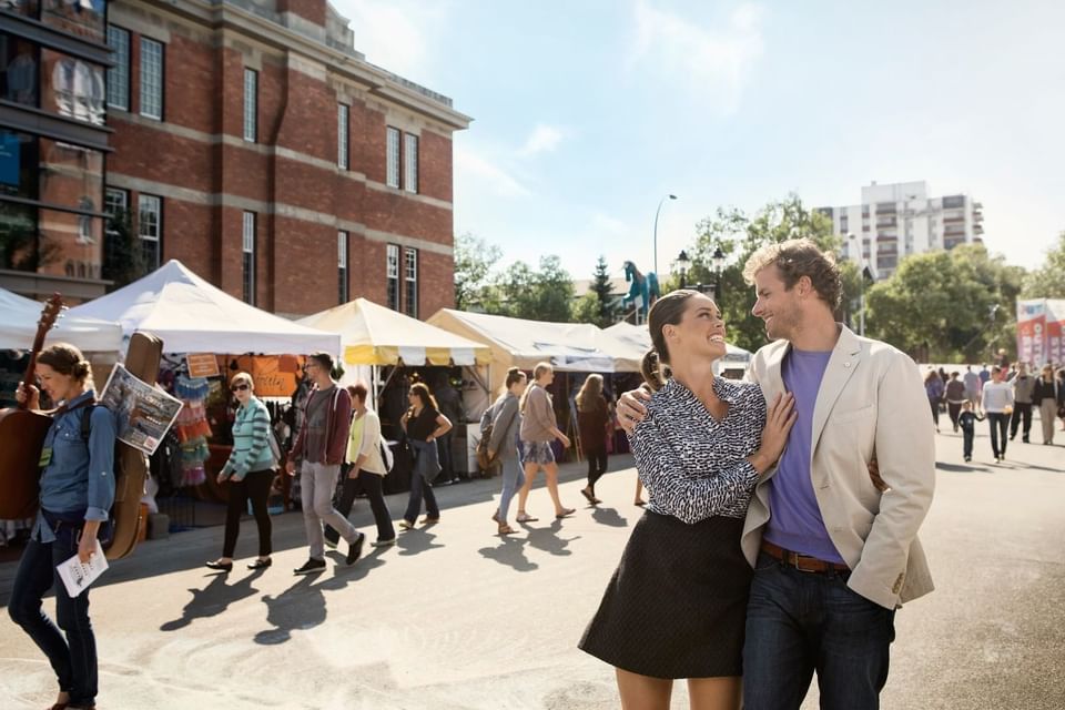 A couple walking down the shop market streets near Metterra Hotel on Whyte