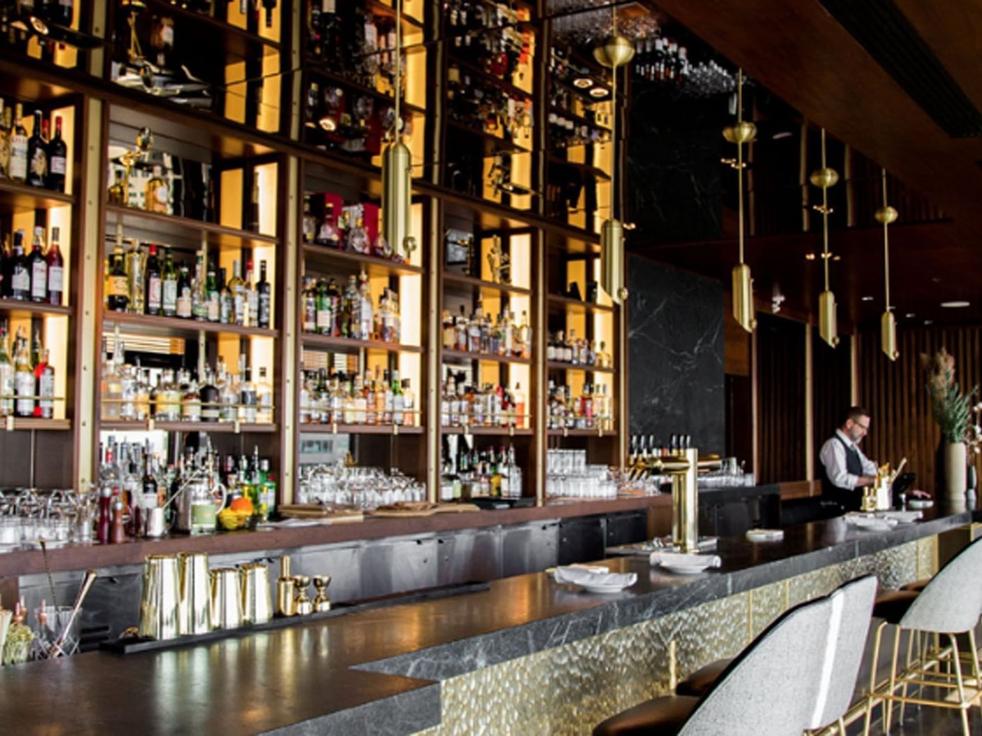 Interior of a bar with shelves of bottles in Canoe Restaurant near Hotel X, hotels in Toronto downtown