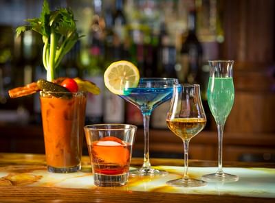 A colorful selection of five cocktails, served in Cascades Restaurant on a bar counter at The Stanley Hotel