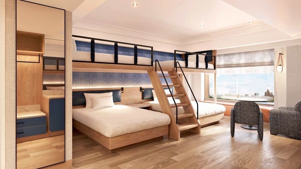 Twin beds facing TV console and vanity mirror with open doorway leading to adjacent bedroom in Connecting Rooms at Grand Park Otaru