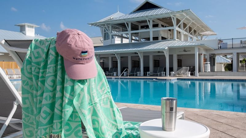 Closeup of towel, cap, drink by the pool at WaterSound Inn