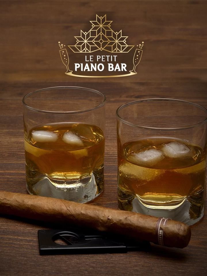 Whiskey glasses with a cigar served on a table in Le Petit Piano Bar at Warwick Palm Beach Hotel