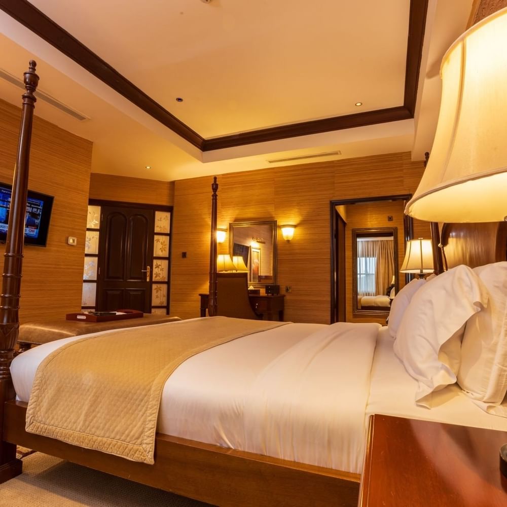 Presidential Suite with a large bed and luxurious decor at Lake Victoria Serena Golf Resort & Spa in Kampala.