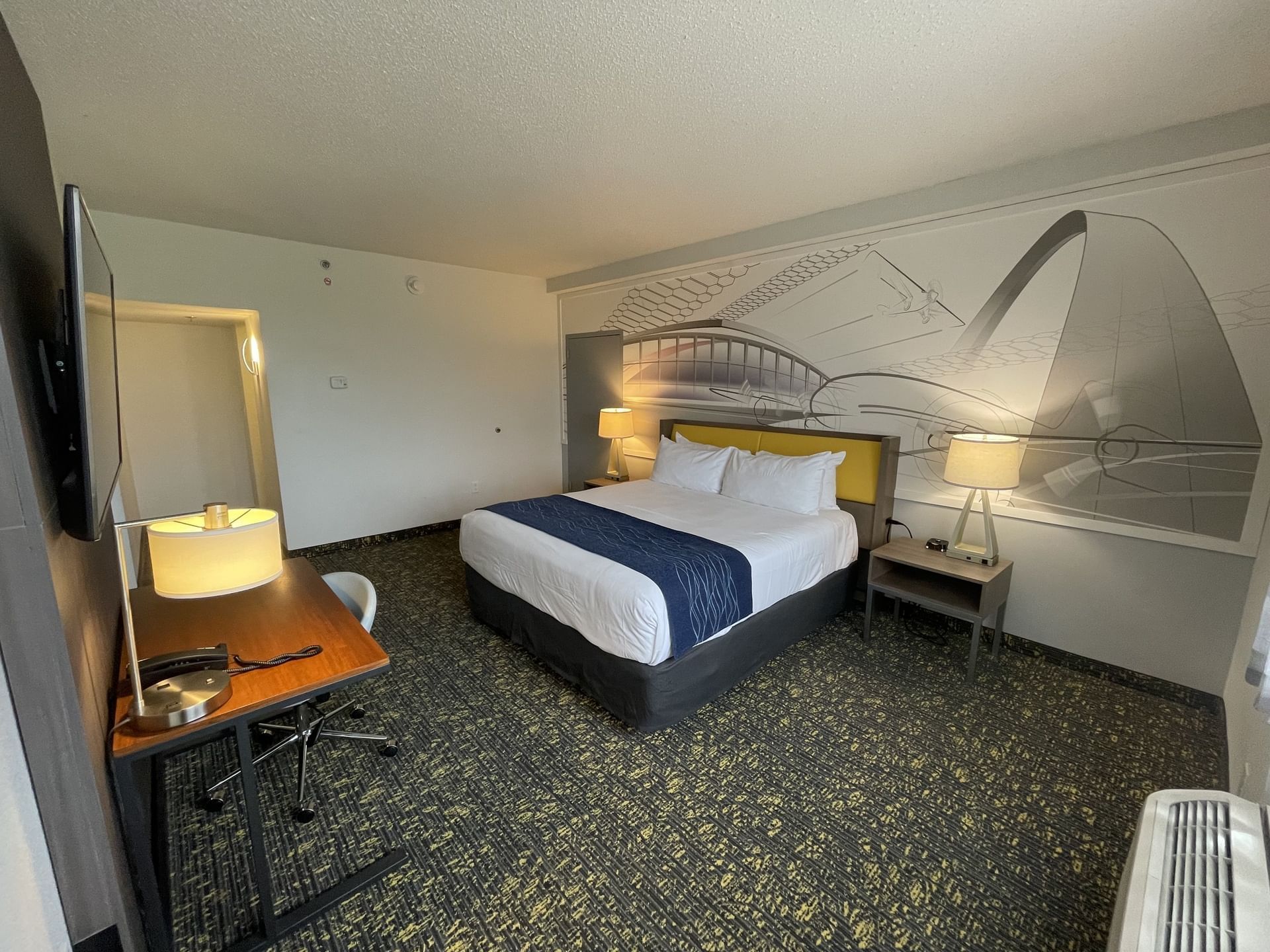 King bed, nightstand & working table with TV in King Executive Suite at St. Louis Airport Hotel