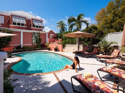 Lady sitting on the outdoor swimming pool area at Royal Palms Hotel