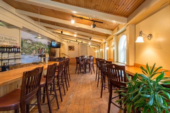 Bar area with bar stools at Wolfeboro Inn