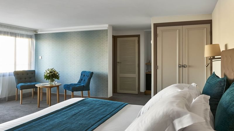 Queen bed and coffee table in Deluxe at Splendid Hotel & Spa Nice