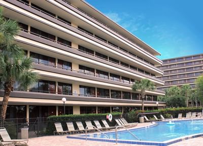 Exterior of hotel building & outdoor pool at Rosen Inn at Pointe Orlando