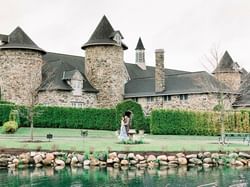 Couple posing in Castle Farms by the lake with greenery surroundings near The Earl