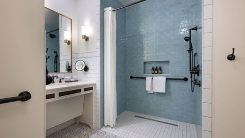 Bathroom vanity & shower area in Golf View Queen Room at Camp Creek Inn