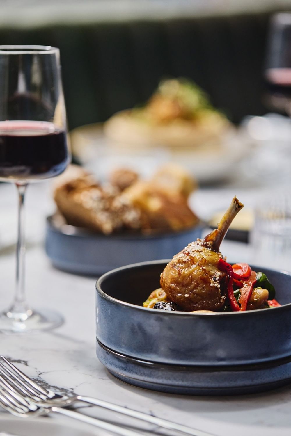Roasted lamb chop with vegetables served alongside red wine at The Bedford Hotel Belfast