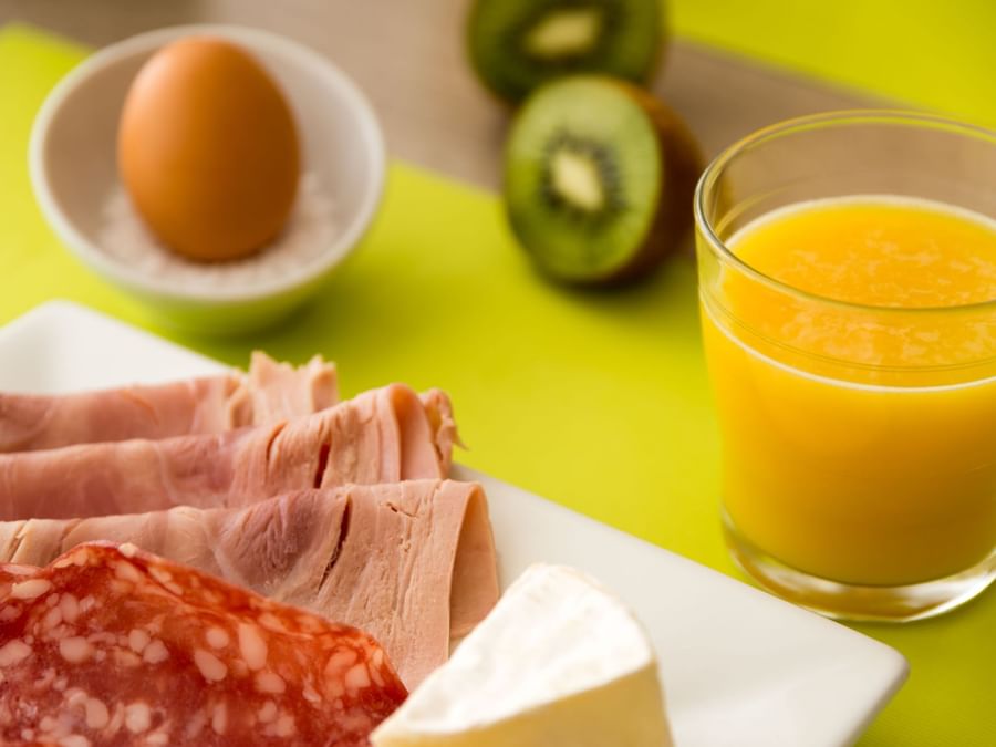 Closeup of a morning snack plate with fresh juice 
