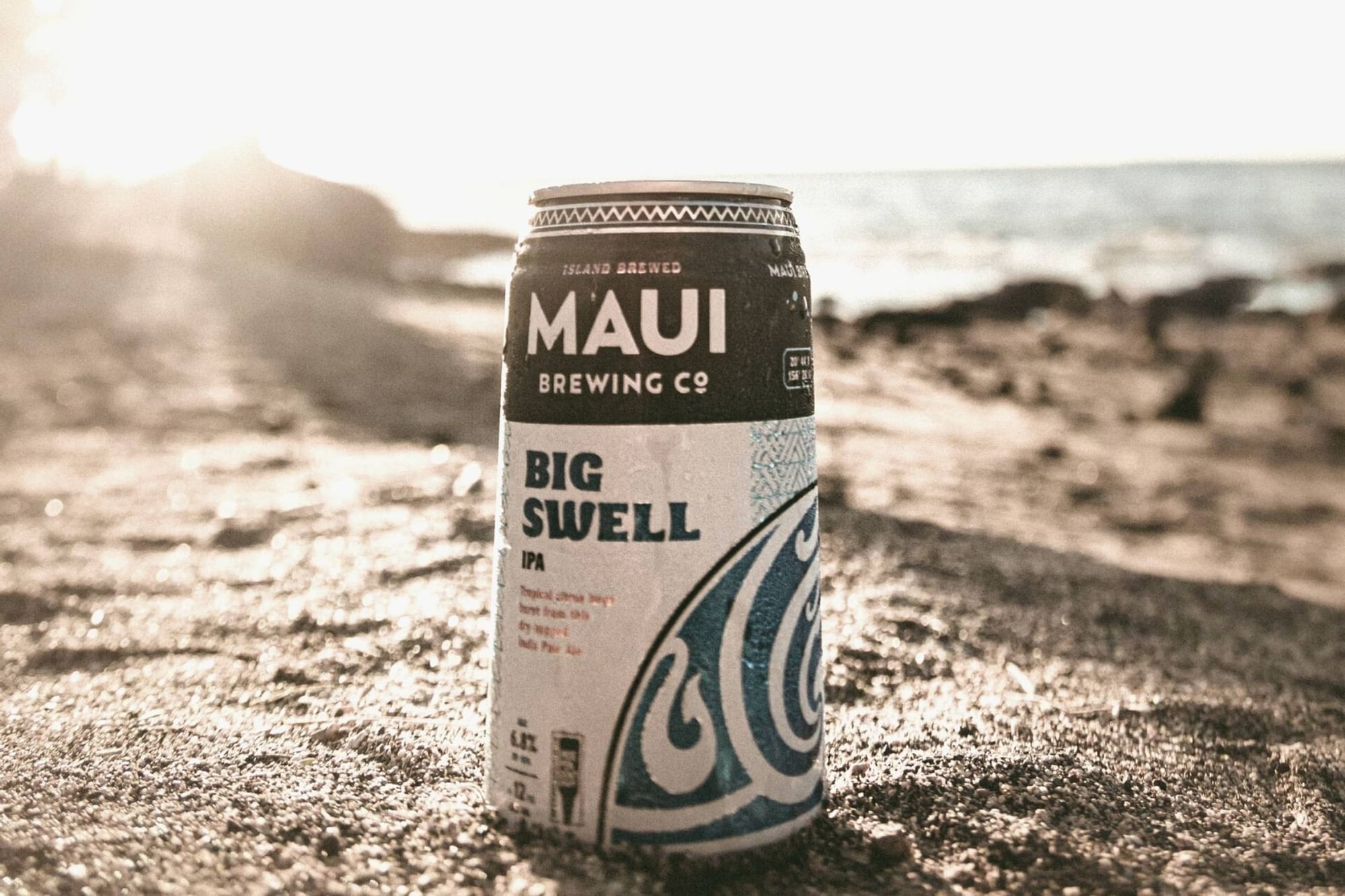 Maui Brewing beer can stands on the beach near Waikiki Resort Hotel