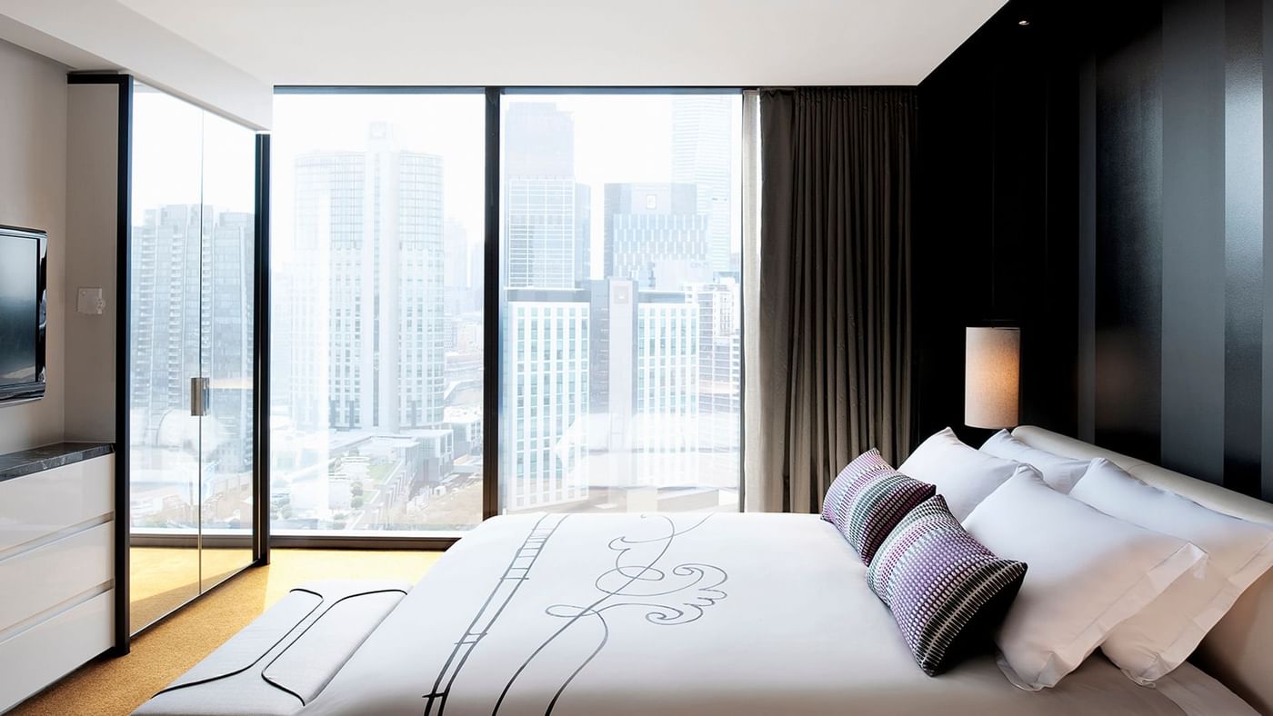 Interior of Func Room Loft with a cozy king bed overlooking the city at Crown Hotels