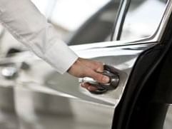 Close up on concierge opening the car door