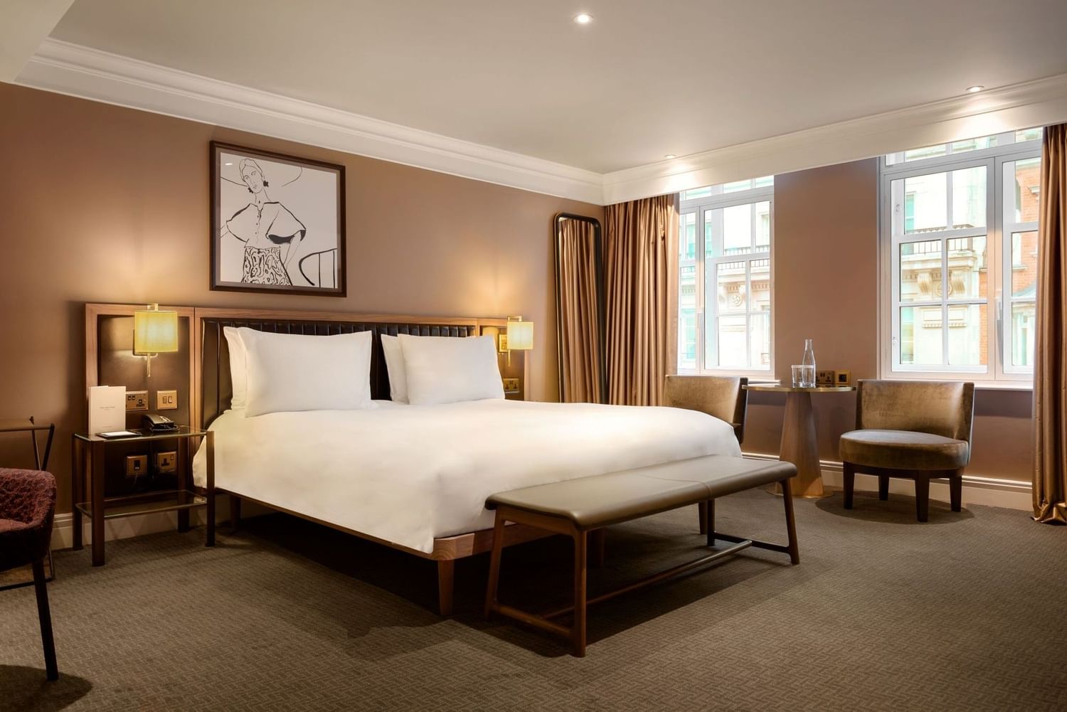 Elegant hotel room with large bed, wooden furniture, and modern decor at The May Fair Hotel, London