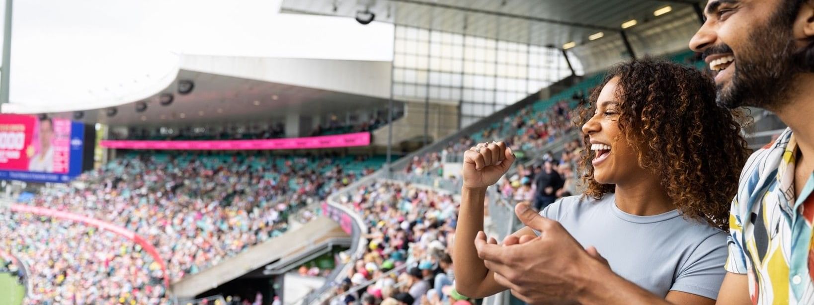 Excited fans cheering in a packed cricket stadium during Australia v England T20 International 2027
