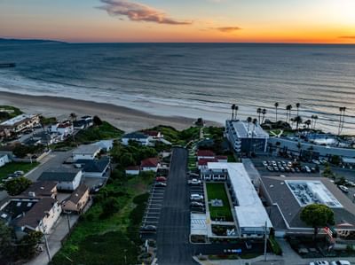 Aerial view of hotel and ocean at sunset