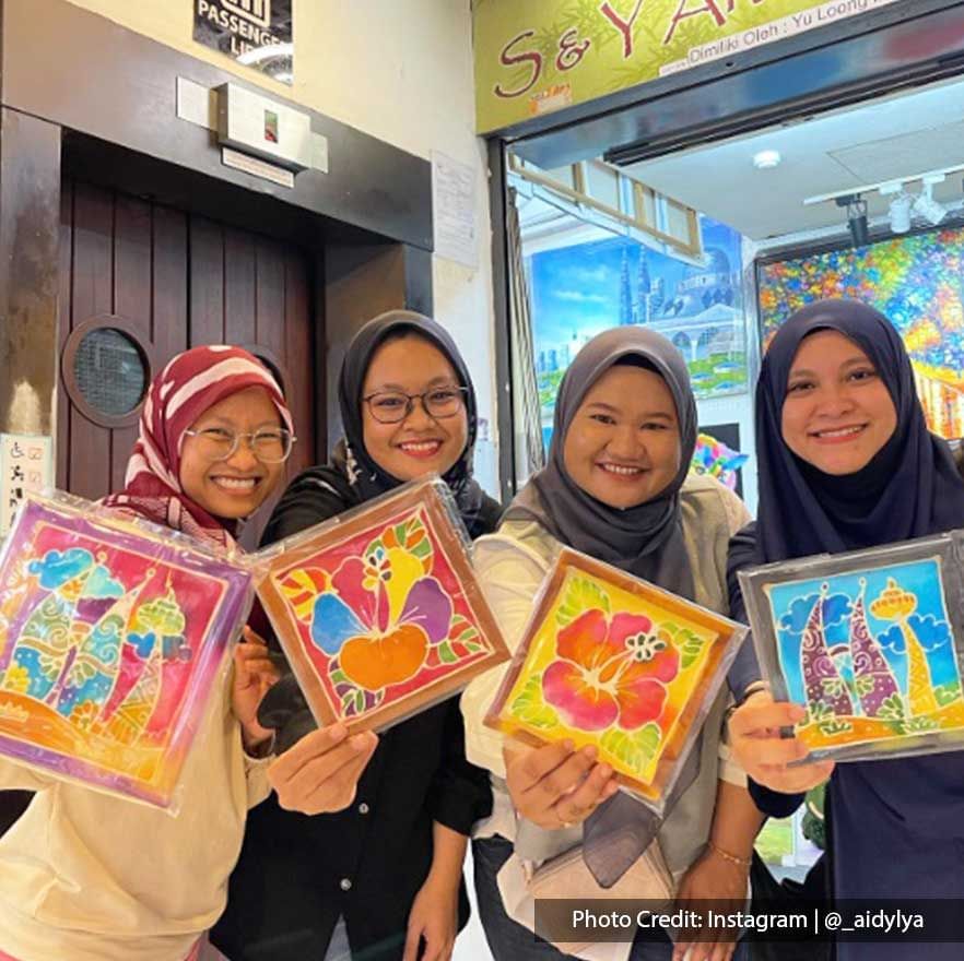 Girls holding paintings in Central Market, recreational activities near Imperial Lexis Kuala Lumpur