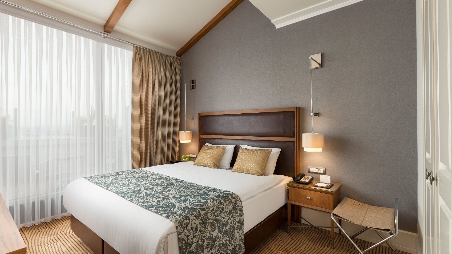 Comfy bed with side tables in Executive Room at Titanic City Taksim