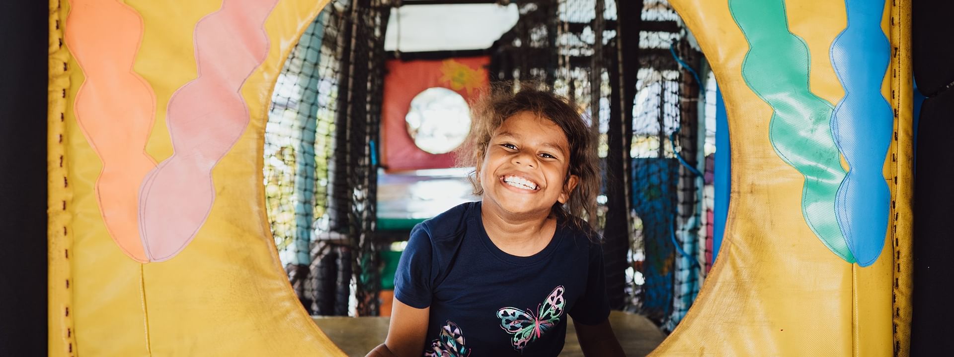Smiling girl inside the Funtastik Kids Club play area at Warwick Le Lagon Efate