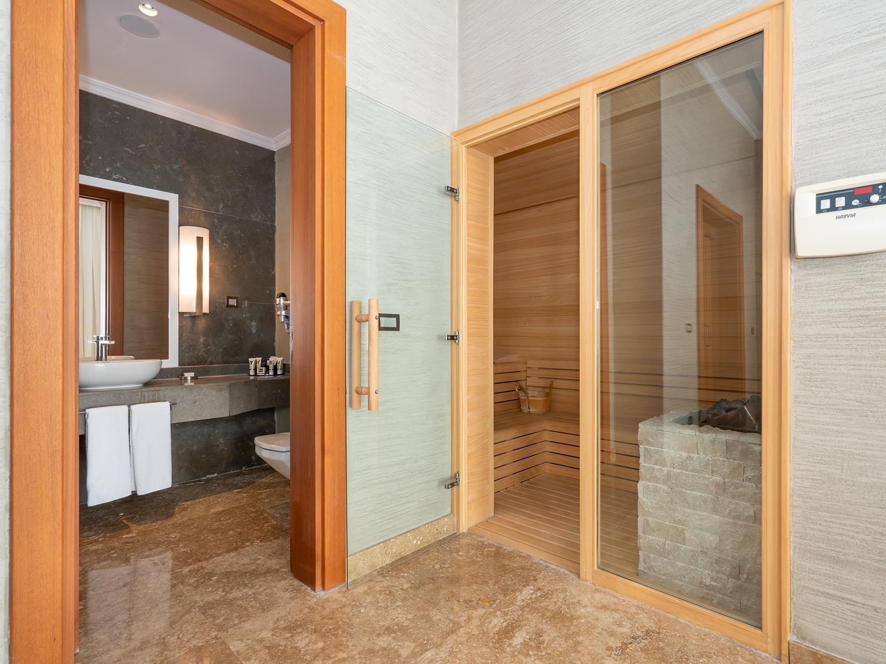 Bathroom vanity and wooden sauna room in Ottoman Spa Suite at Titanic Deluxe Golf Belek