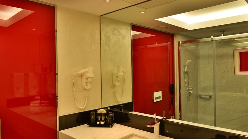 Bathroom marble vanity and amenities in Deluxe room at Warwick Ankara
