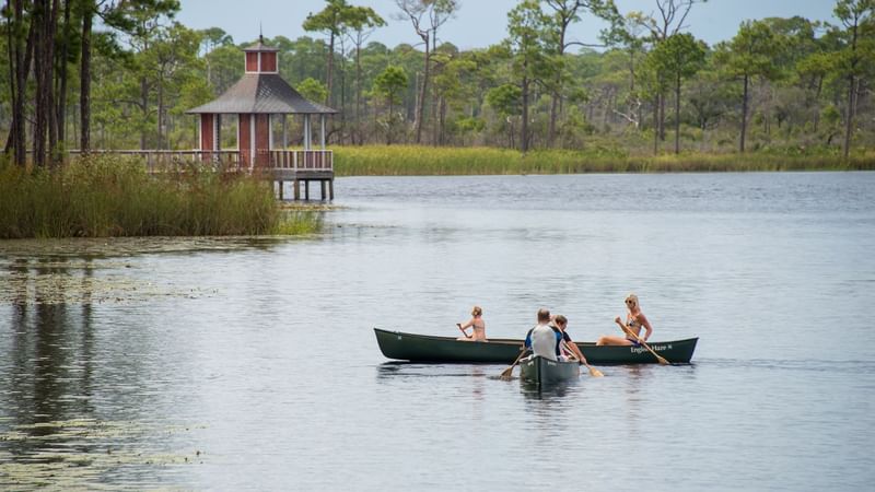 A Family canoeing on the lake near the WaterColor Inn