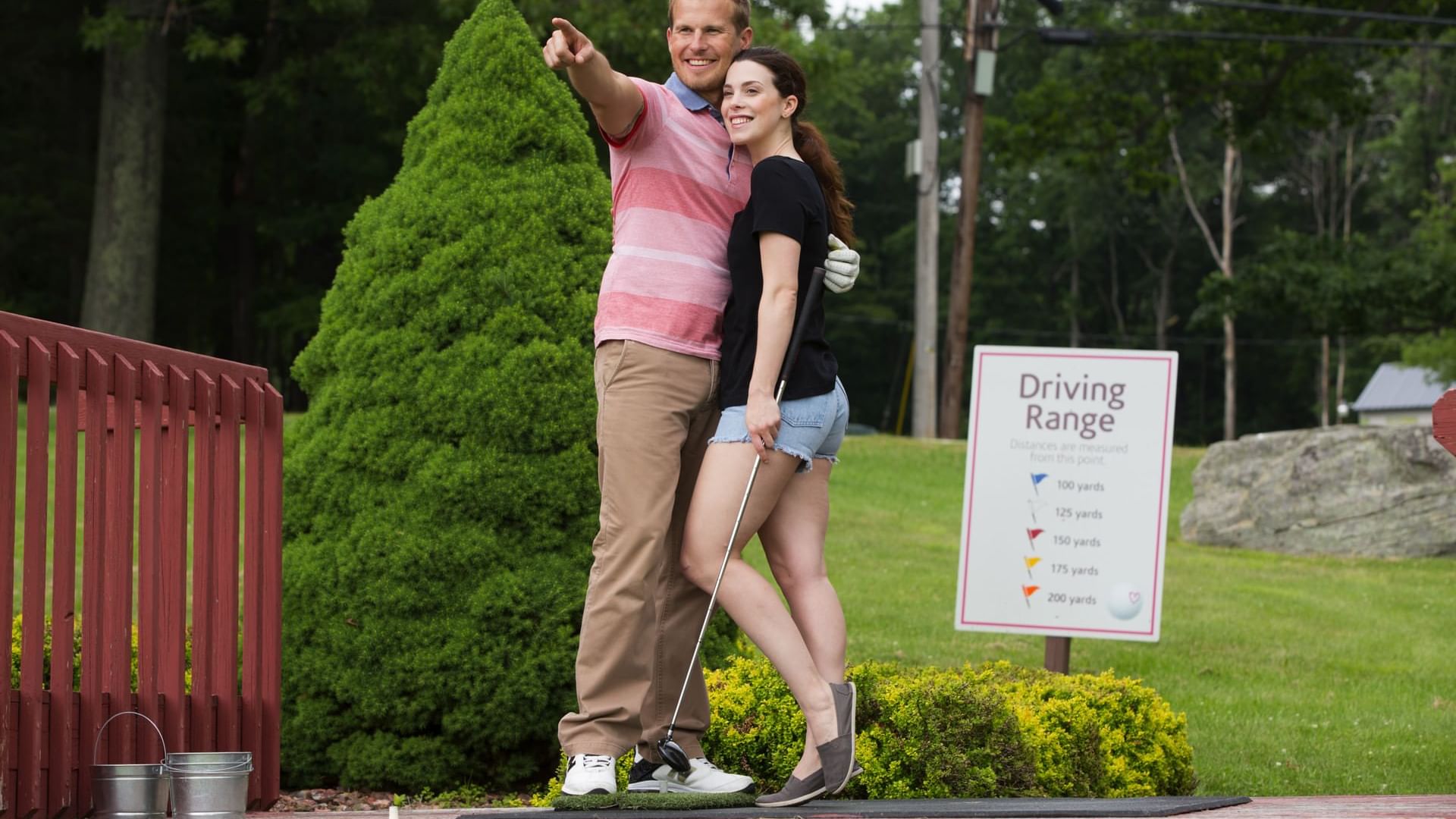 Couple overlooking the shot they took at miniature golf in Cove Pocono Resorts