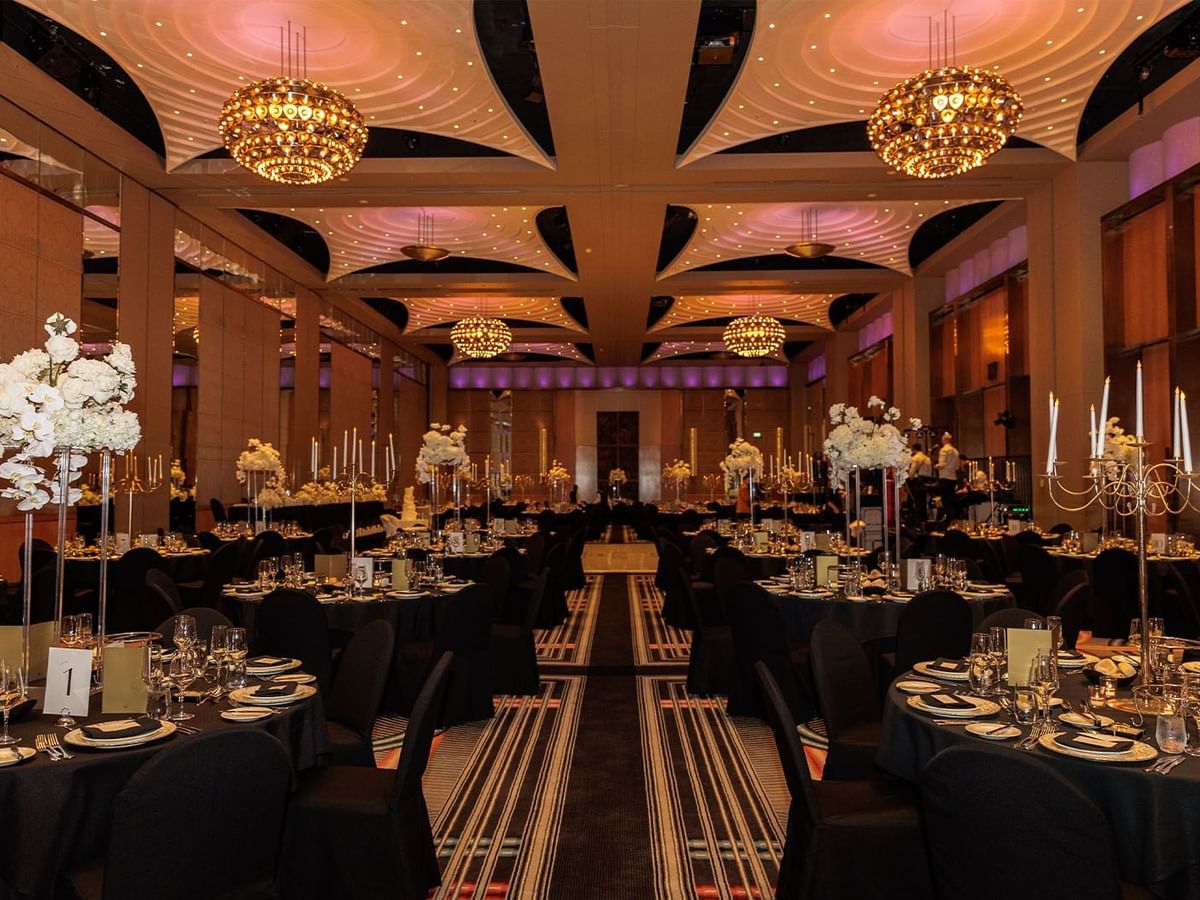 Banquet hall with floral decor and candles for Clarissa and Kristian's wedding at Crown Towers Perth