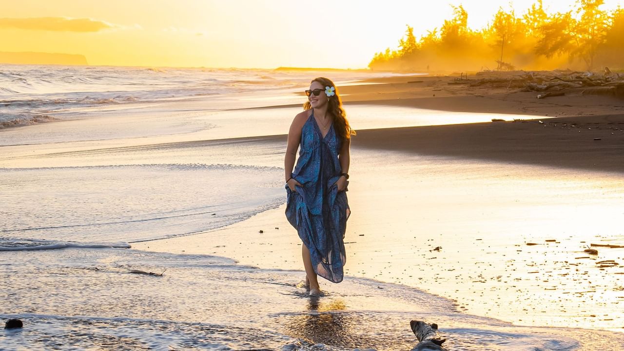 A woman strolling along the sandy beach