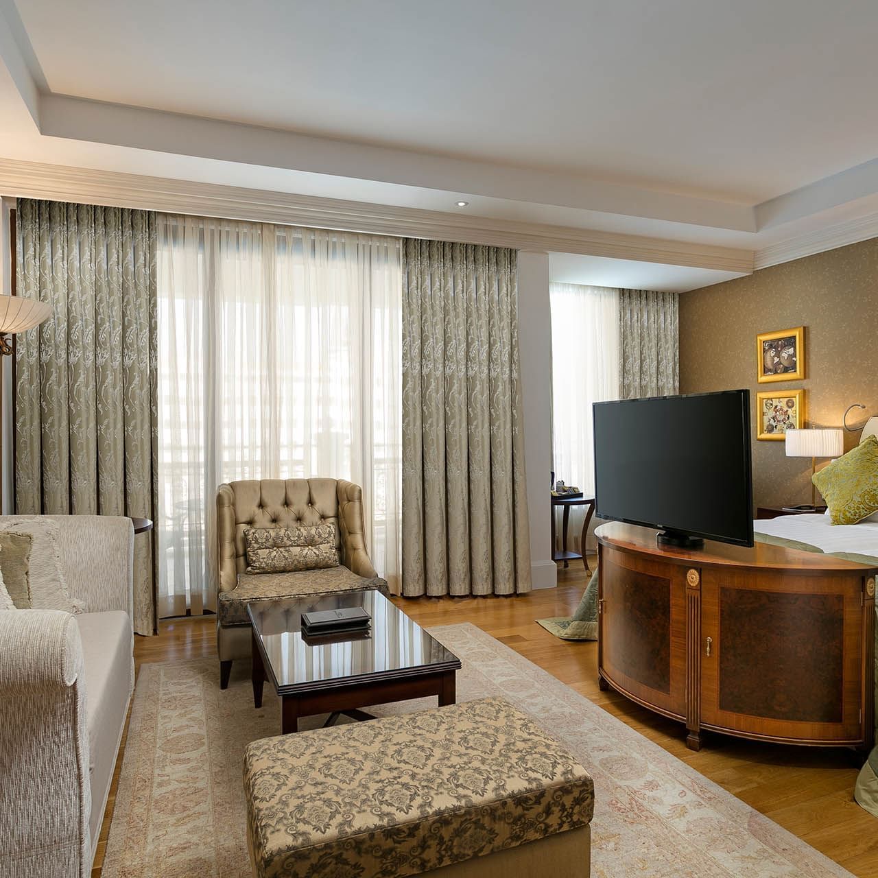 Lounge area with TV in Premium Sea/Pool View Room at Titanic Mardan Palace