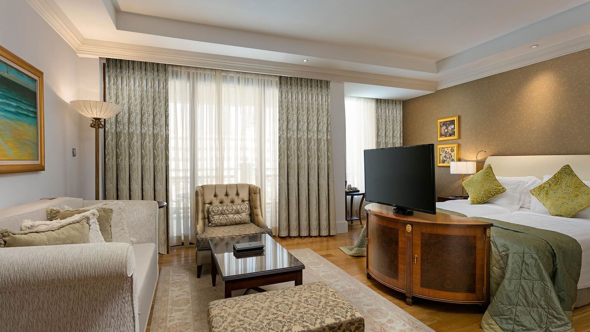 Lounge area with TV in Premium Sea/Pool View Room at Titanic Mardan Palace