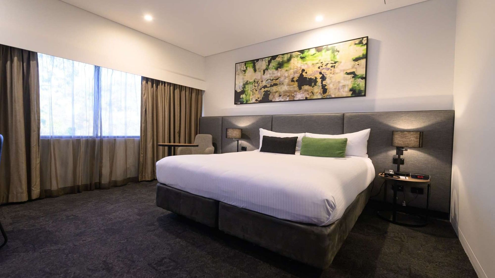 A Superior King Room at Mercure Penrith in Penrith with bed, curtains, and artwork.
