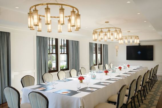 Long conference table arranged in the Hotel Atwater Boardroom at Hotel Atwater