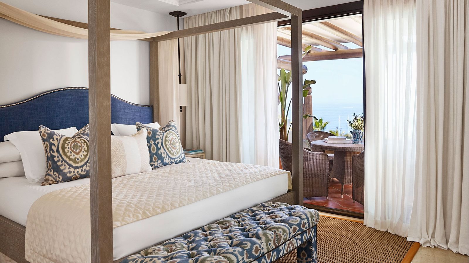 Imperial Beach Suite featuring a four-poster bed, headboard, & terrace with a stunning sea view at Marbella Club