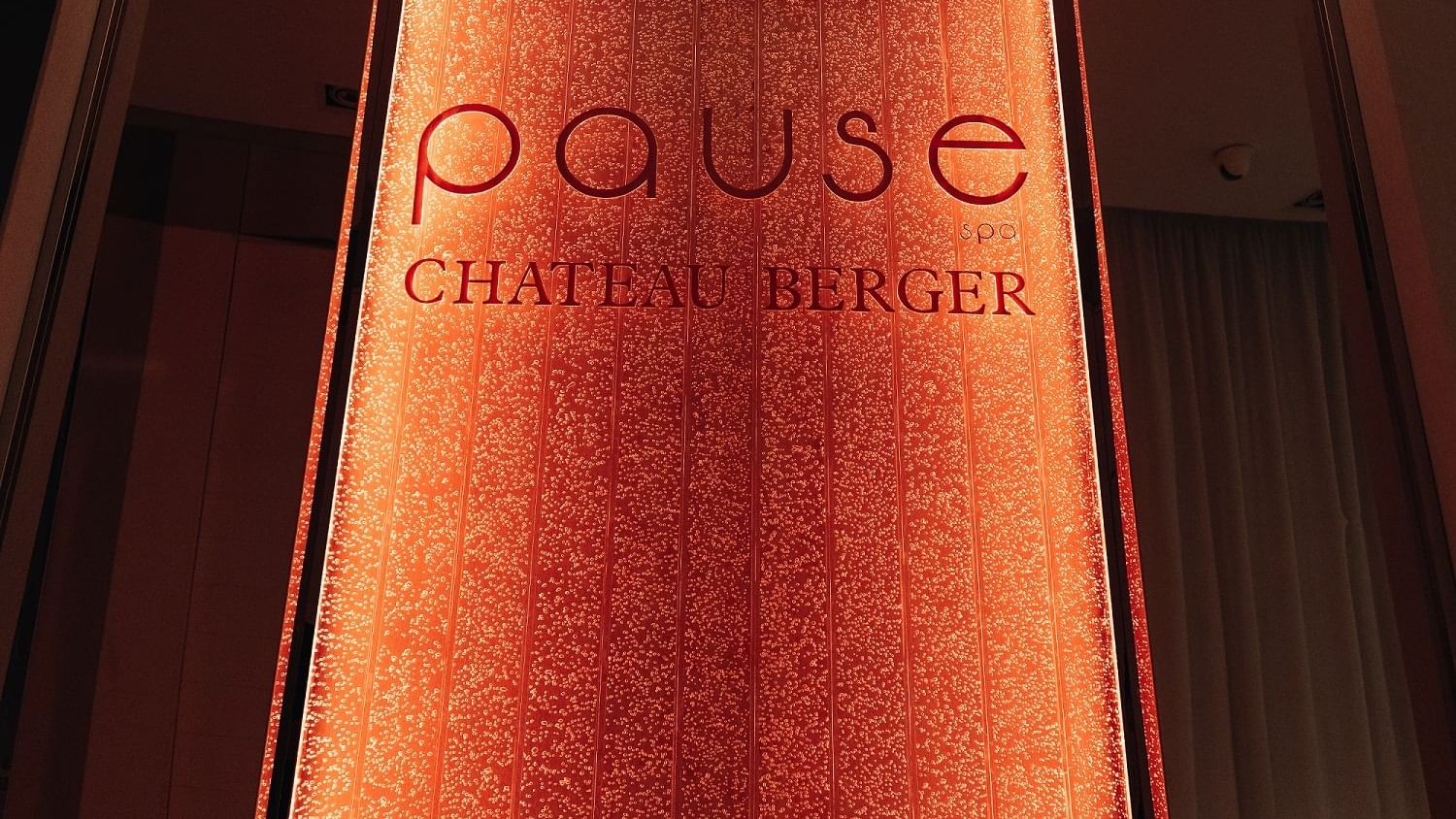 Lit-up red sign for the Pause Chateau Berger Spa at Paramount Hotel Dubai