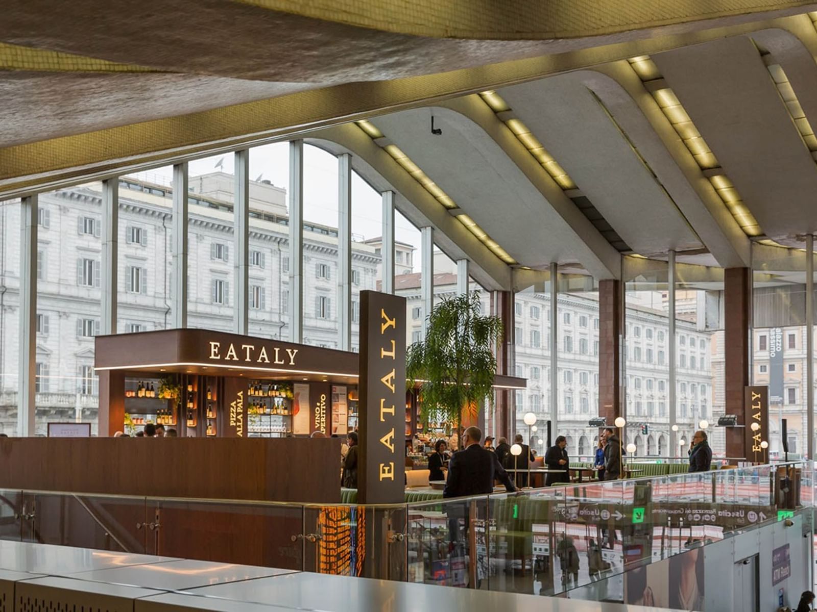 Eataly restaurant with modern interior, and large windows offering city views near The Guardian Hotel