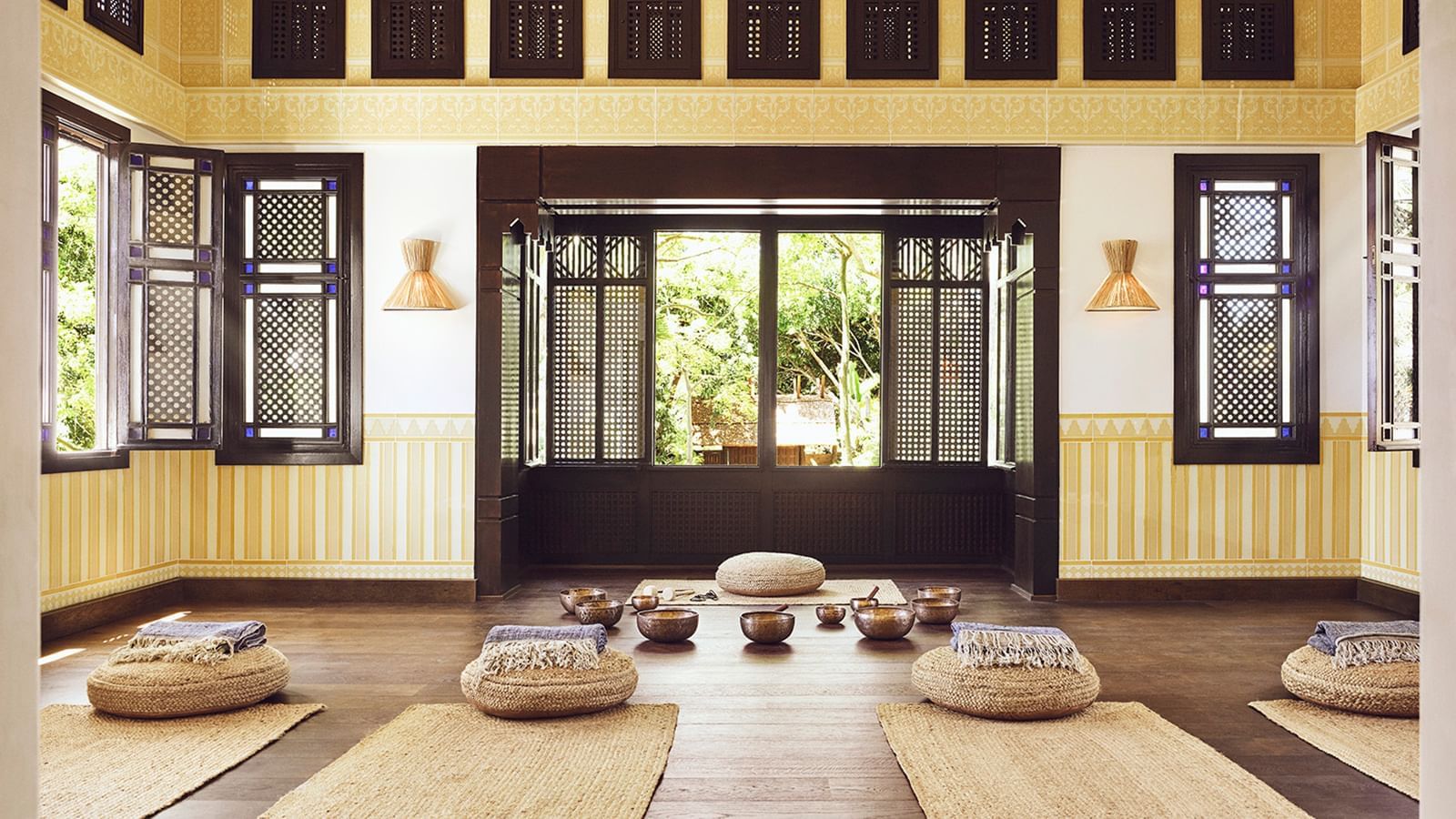 Meditation room, with yoga mats and cushions placed on the floor under a decorative window at the Marbella Club