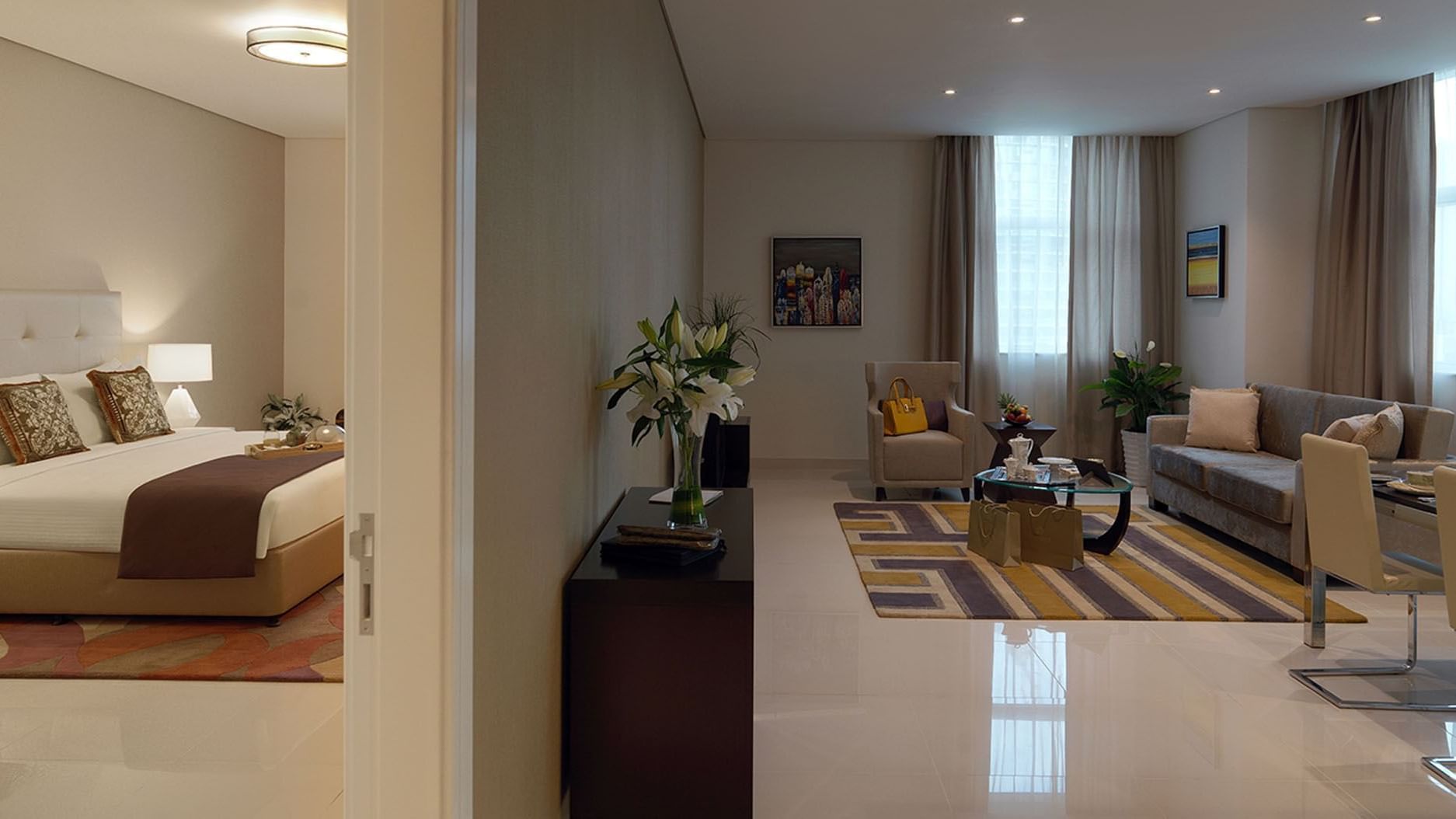 Bedroom & living area featuring modern furniture in Deluxe Room at DAMAC Maison Cour Jardin