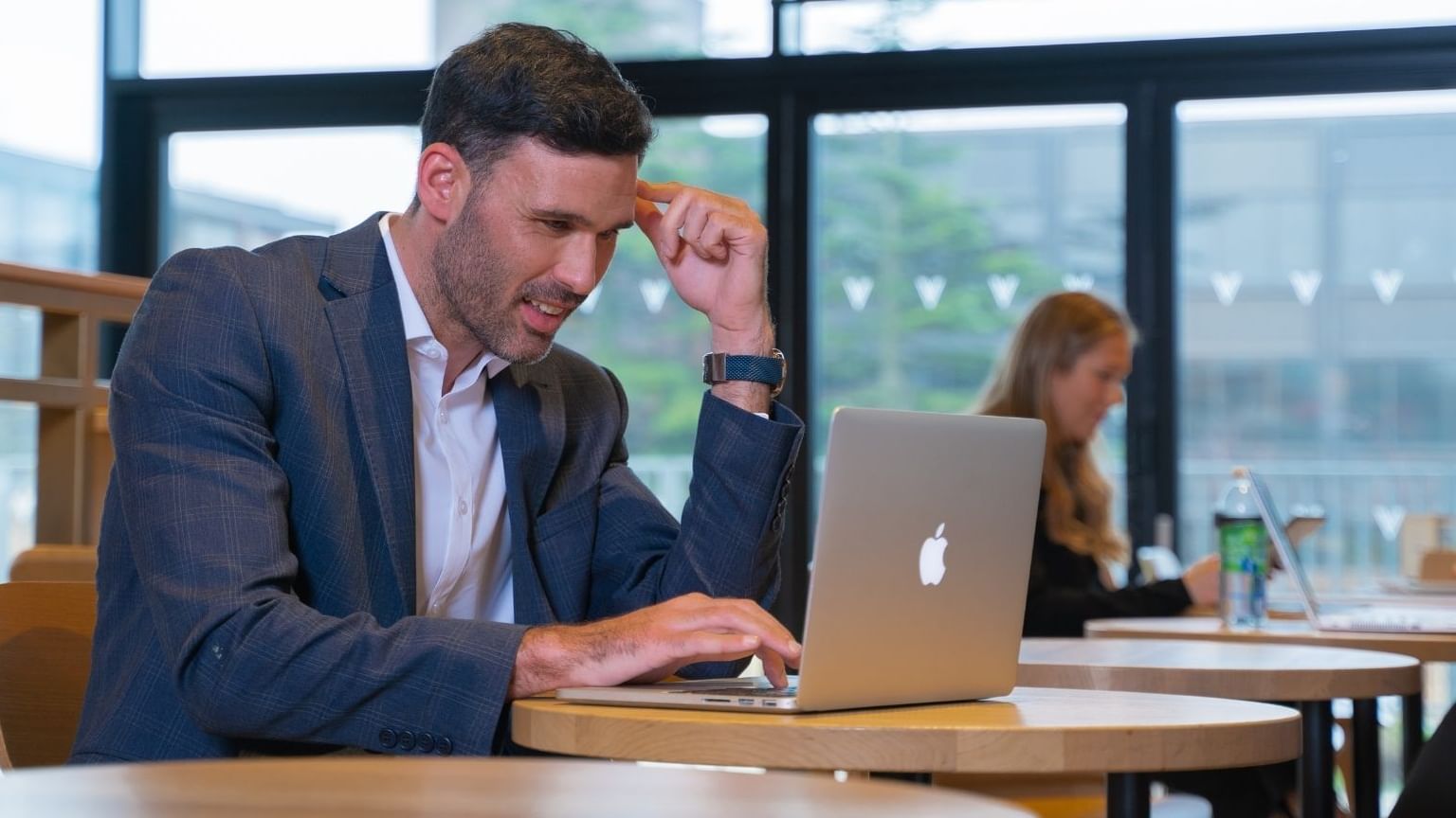 Man in a suit working in his laptop at Village Hotel Cheadle