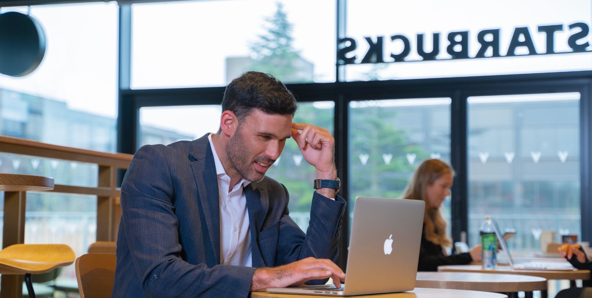 A man in a suit working on his  laptop at Village Hotel Wirral