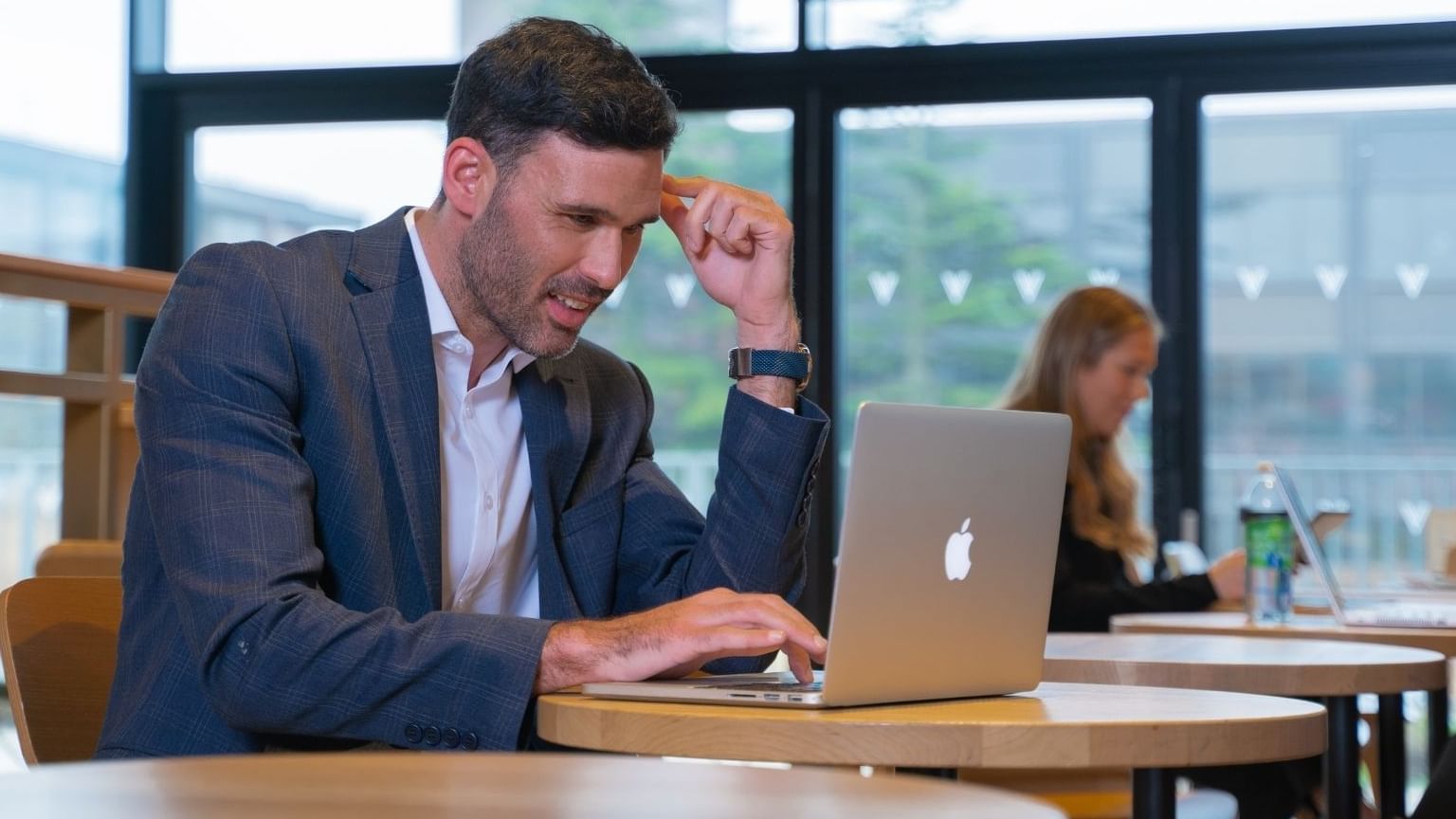 Man in a suit working in his laptop at Village Hotel Cheadle