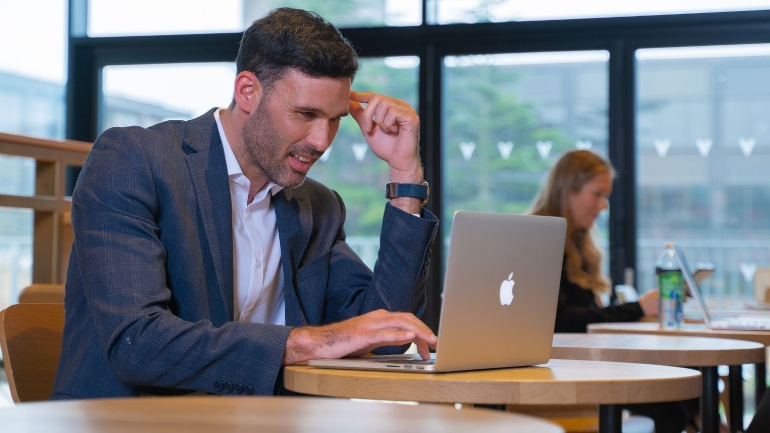 Man in a suit on a laptop at Village Hotel Leeds North