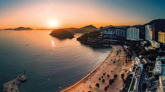 Aerial view of the city & coastline at sunset near Park Hotel Hong Kong