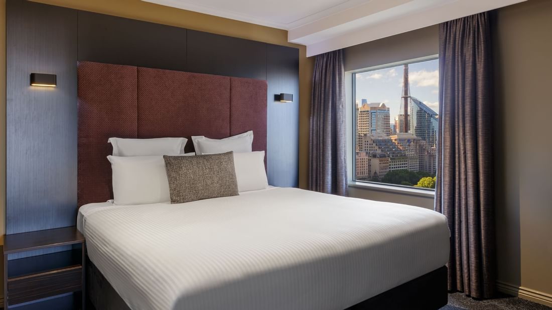 Cozy bed overlooking the city in Junior Suite at Pullman Sydney Hyde Park