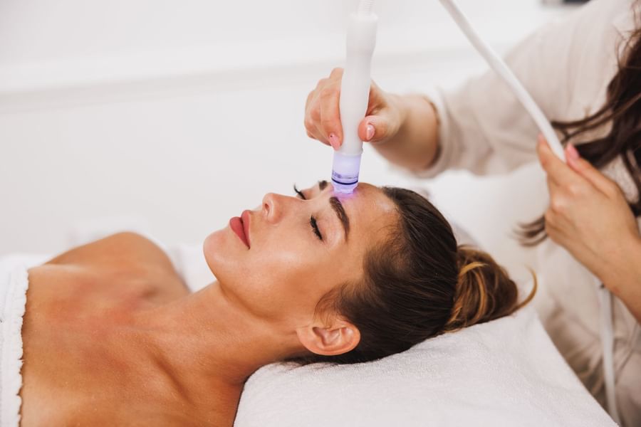 Close-up of a fair lady getting a facial treatment on a spa bed at The Diplomat Resort