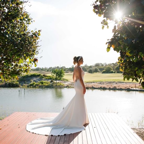 Bride posing by the lake near Pullman Magenta Shores